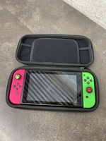 NINTENDO SWITCH WITH FLUORSCENT PINK AND GREEN JOY CON WITH GREY TRAVEL CASE